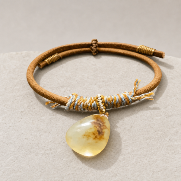 S15 amber-tone corded teardrop accessory on a light stone surface